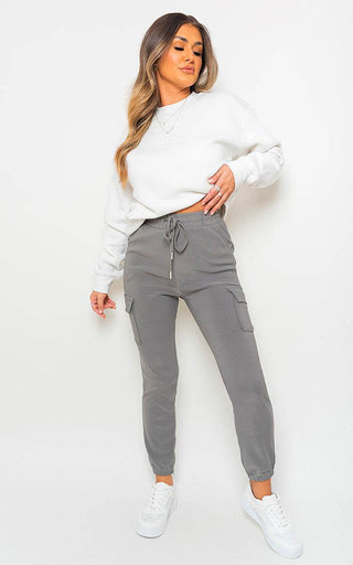 Cargo Pocket Trouser with drawstring in grey featuring utilitarian cargo pockets, styled with a white sweatshirt.