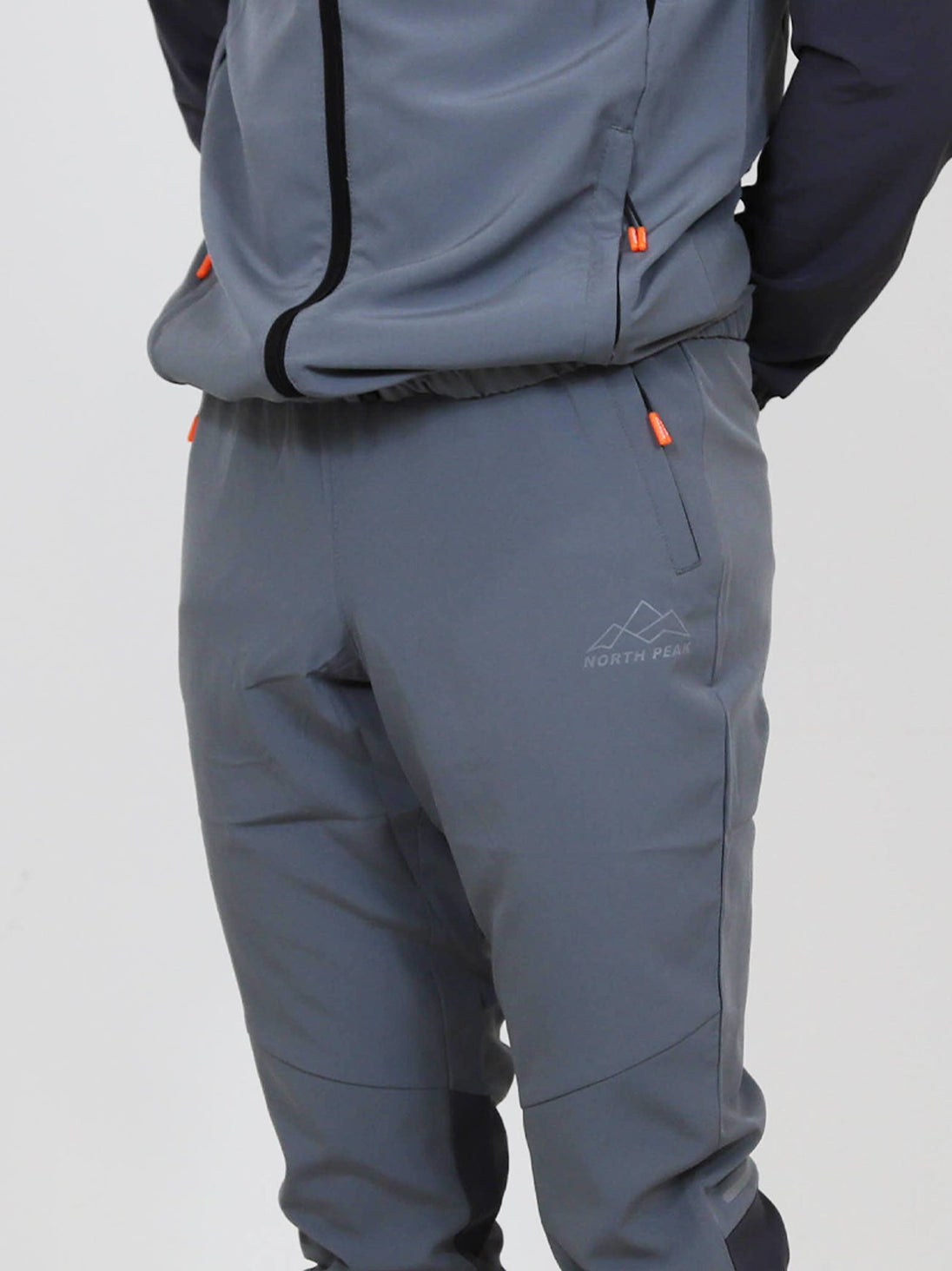 North Peak Glacier Track Pant in grey, lightweight, moisture-wicking activewear with zipper pockets and athletic fit.