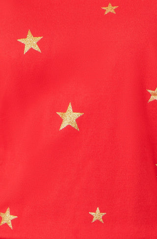 Close-up of red jumper with gold foil star print on soft knit fabric