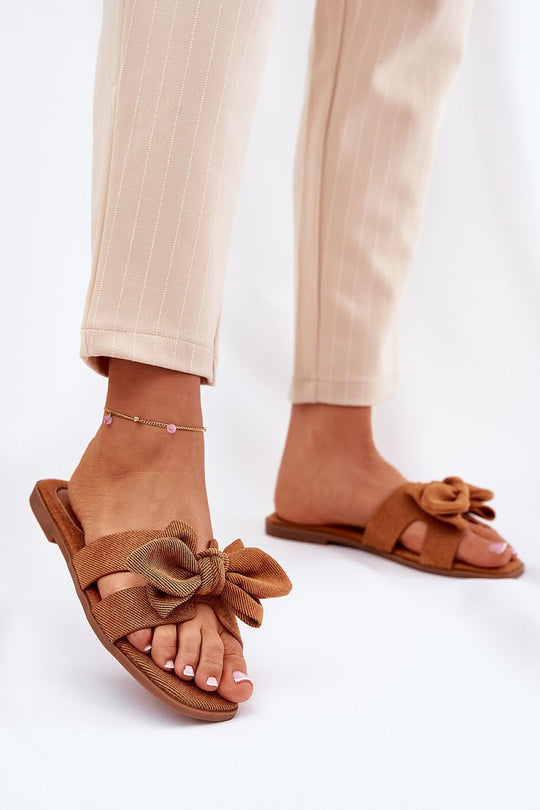 Summer flip-flops with textile material, featuring a flat heel, cut-outs, and a bow design; perfect for dresses, skirts, and shorts.