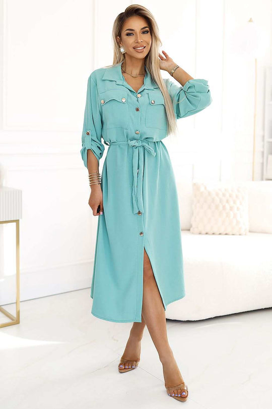 Women's dress with gold buttons and waist tie, elegant and versatile, ideal for various occasions.