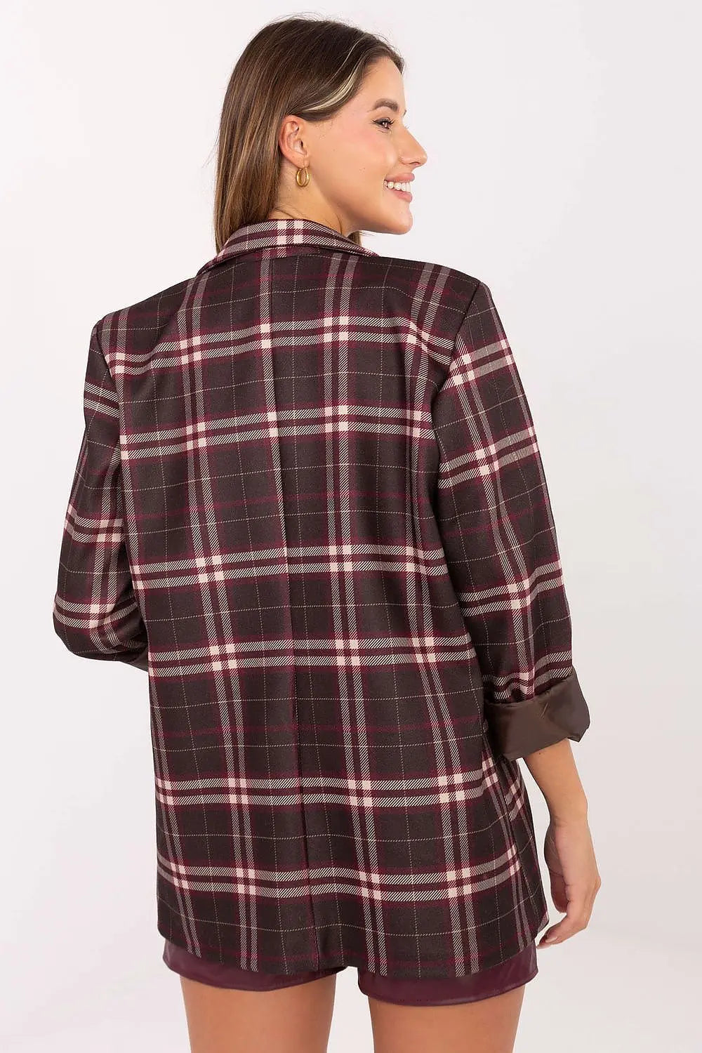Back view of woman wearing a stylish women’s checked blazer with classic checkered pattern and long sleeves