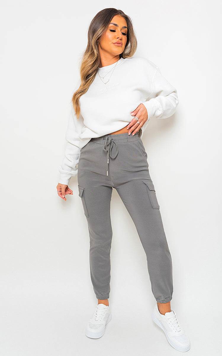 Cargo Pocket Trouser with drawstring in grey featuring utilitarian cargo pockets, styled with a white sweatshirt.